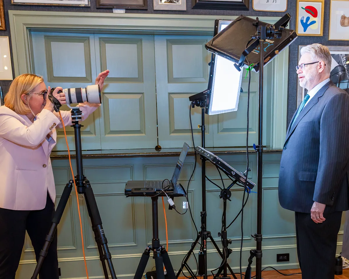 Philadelphia headshot photographer Isolde Baylor directing a corporate headshot session at The Radnor Hotel with professional lighting and tethered monitoring